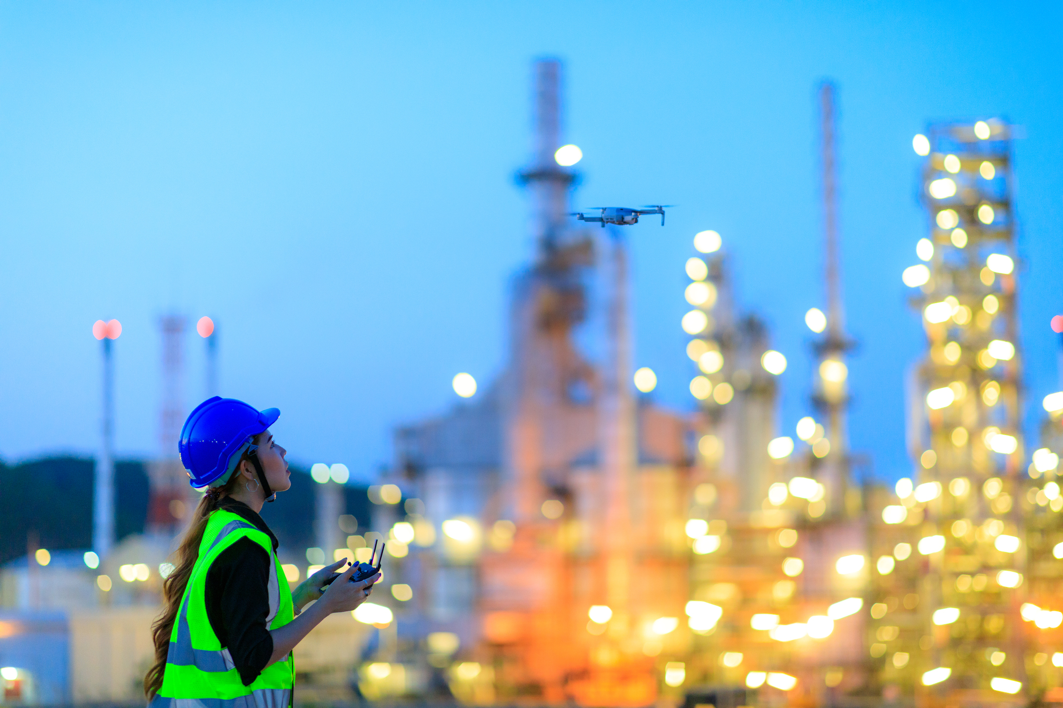 L&W Supply Women Employee Using Drone For Top View Inspection At The Refinery Plant