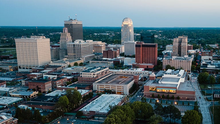 Aerial View as Night Falls on the Downtown City Skyline at Winston-Salem