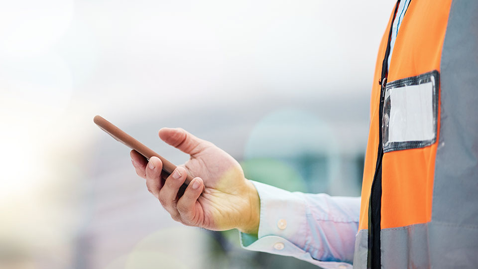 Contractor on Job Site with a Smart Phone